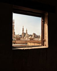 A view from a window that show collection of historic building and mosques 