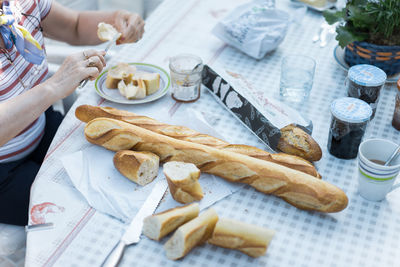 Midsection of woman preparing breakfast at table