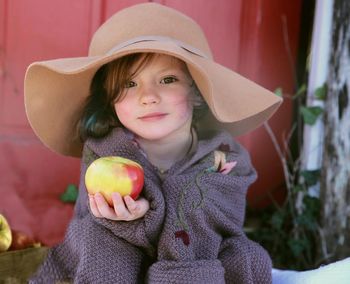 Portrait of cute girl holding food