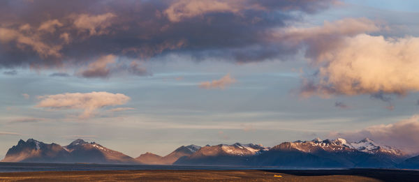 Panoramic view of snowcapped mountains against sky during sunset