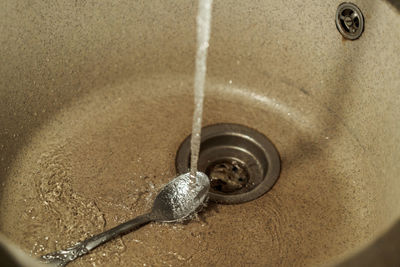 High angle view of water from faucet in bathroom