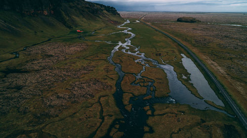 High angle view of land and mountains against sky