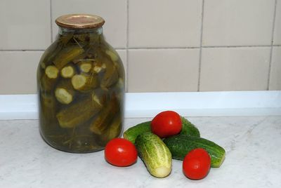 Close-up of fruits in glass container on table