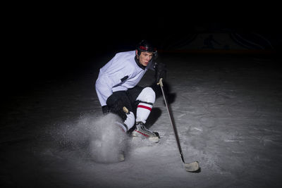 Portrait of young man playing ice hockey