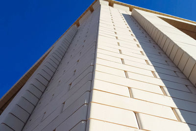 Low angle view of building against clear blue sky