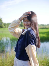 Rear view of young woman standing in forest