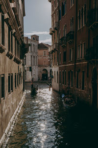 Gondolas on a narrow canal in venice, italy.