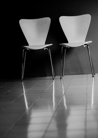 Empty chairs on tiled floor