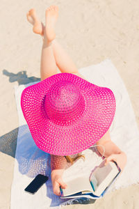 High angle view of woman sitting on sand