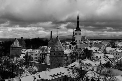 Buildings in city against sky during winter