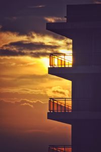 Low angle view of silhouette building against sky during sunset