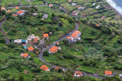 High angle view of houses and trees on field