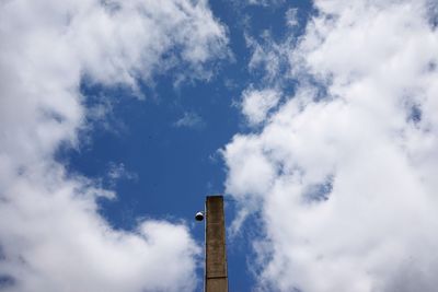 Low angle view of smoke stacks against sky