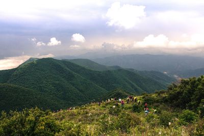 Scenic view of mountains against cloudy sky