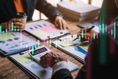 Midsection of business colleagues working at office