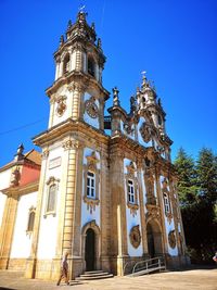 Low angle view of building against clear blue sky