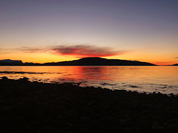 Scenic view of sea against romantic sky at sunset