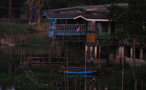 House by lake against trees