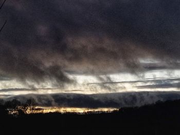 Storm clouds over silhouette landscape