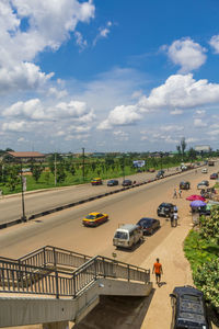 High angle view of vehicles on road in city against sky