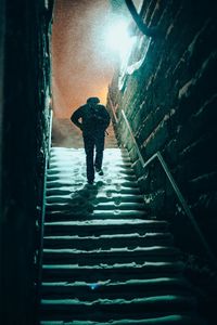 Silhouette man walking on stairs