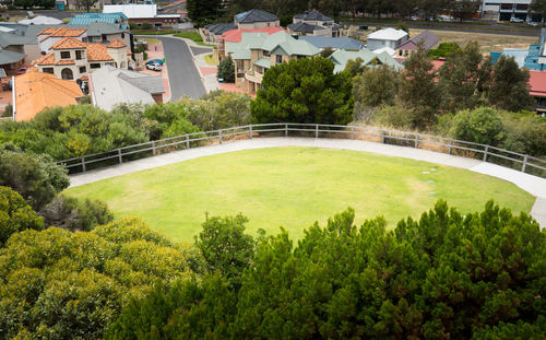 High angle view of swimming pool by buildings in city