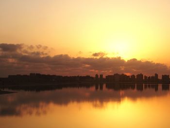 Scenic view of lake against orange sky