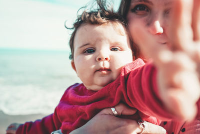 Portrait of mother and daughter at beach