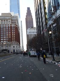 People on city street amidst buildings