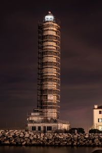 Low angle view of illuminated building against sky at night