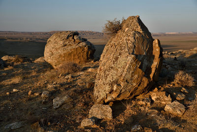 Rock formation on land against sky