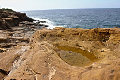 Close-up of beach against sky