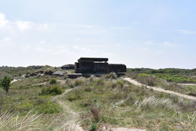 Built structure on field against sky