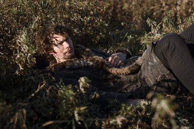 Portrait of man lying down on plants