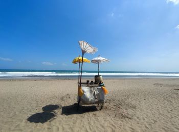 Lifeguard hut on beach against sky