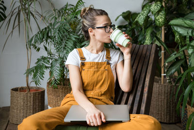 Woman having drink while sitting at home