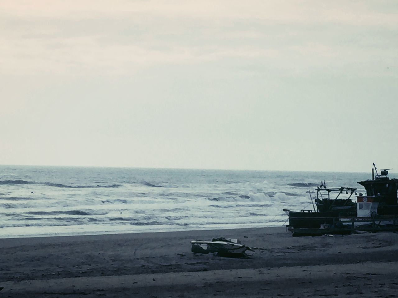 sea, horizon over water, beach, water, shore, sand, nautical vessel, tranquility, tranquil scene, sky, boat, scenics, beauty in nature, transportation, nature, mode of transport, moored, idyllic, day, copy space