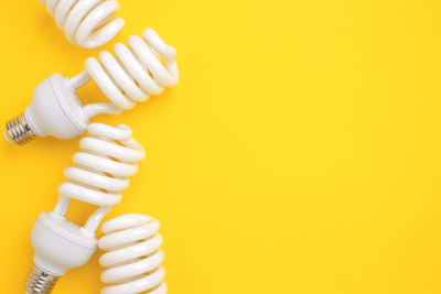 High angle view of cable against yellow background