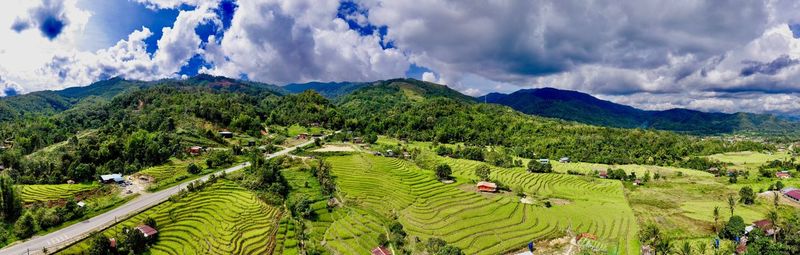 Panoramic view of agricultural field against sky