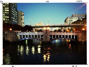 Bridge over river with buildings in background