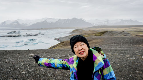 Portrait of smiling woman on land