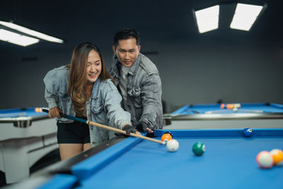 Portrait of woman playing pool