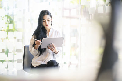 Young businesswoman holding digital tablet