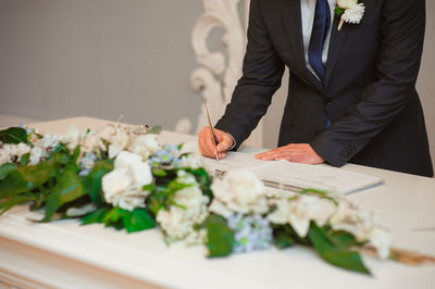 Midsection of man and woman standing on table