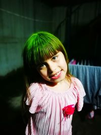 Portrait of smiling girl standing outdoors at night