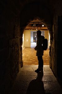 Woman standing in corridor
