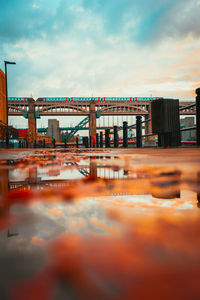 Bridge over river in city against sky