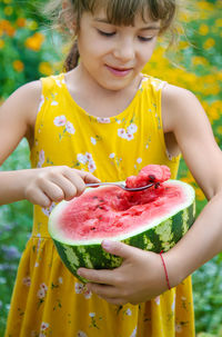 Midsection of woman holding flower