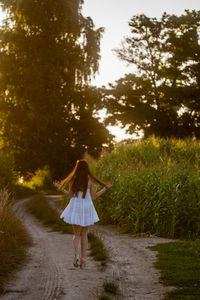 Rear view of woman standing on field