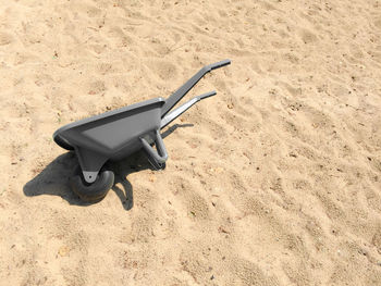 High angle view of wheelbarrow on sand at beach